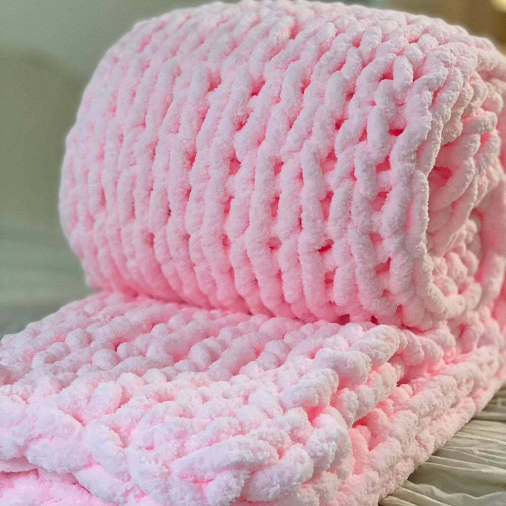 Close view of the Anchor chunky knit blanket in pink, showing the thick tubular weave