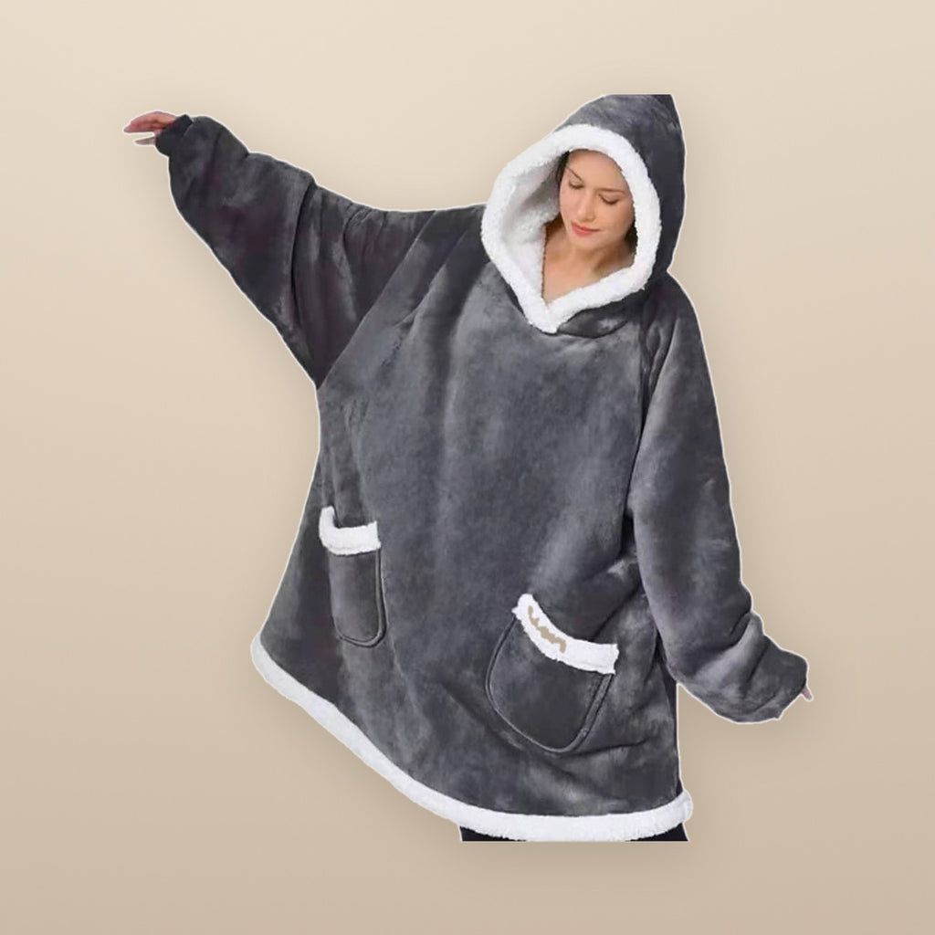 The Burrow oversized hoodie blanket in grey from the side, showing the length and the deep front pockets