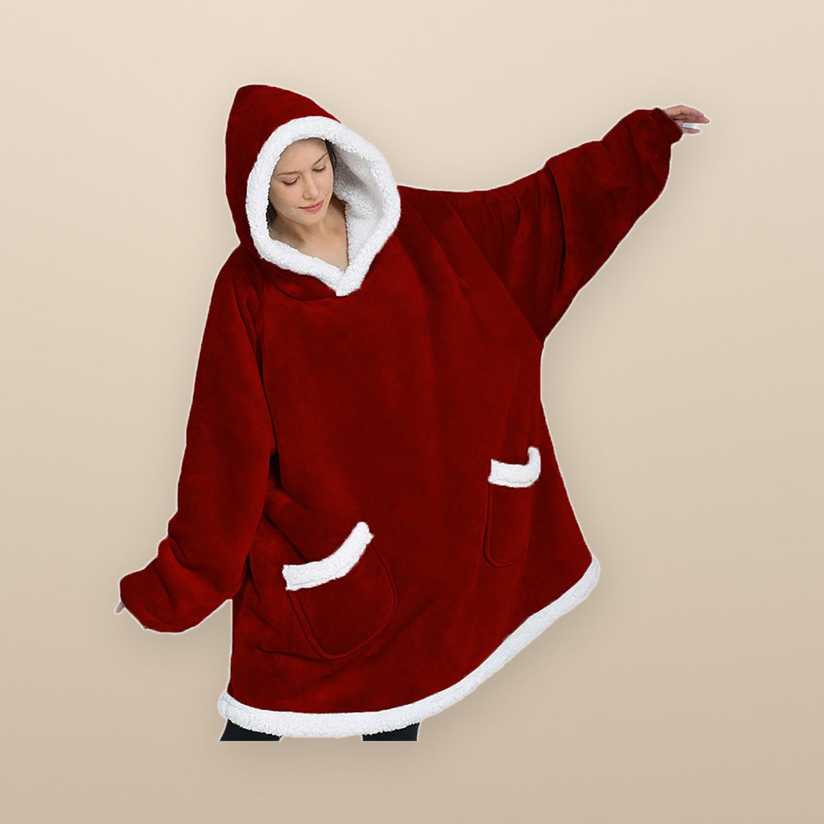 The Burrow oversized hoodie blanket in red, arms out, hanging past the knees