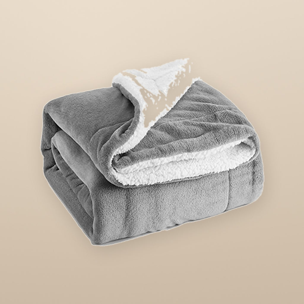 The Hearth reversible sherpa throw in grey, folded to show the fleece side and the sherpa side