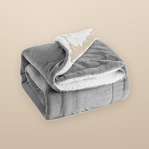 The Hearth reversible sherpa throw in grey, folded to show the fleece side and the sherpa side